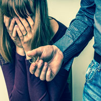 Disappointed man returning the wedding ring to his wife